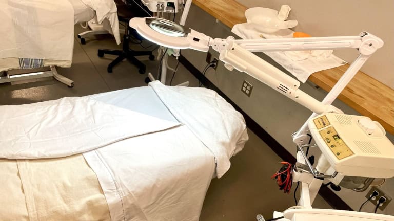 an image of a bed and mirror set up for a spa treatment