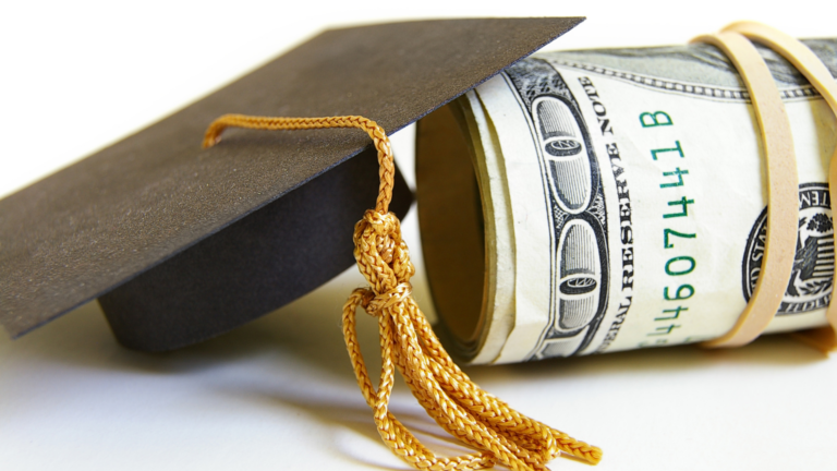 a graduation cap and a roll of money with a tassel