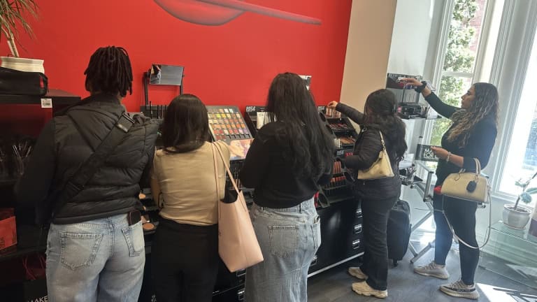 Bryan College students browsing make up during a visit to Make Up For Ever in Toronto