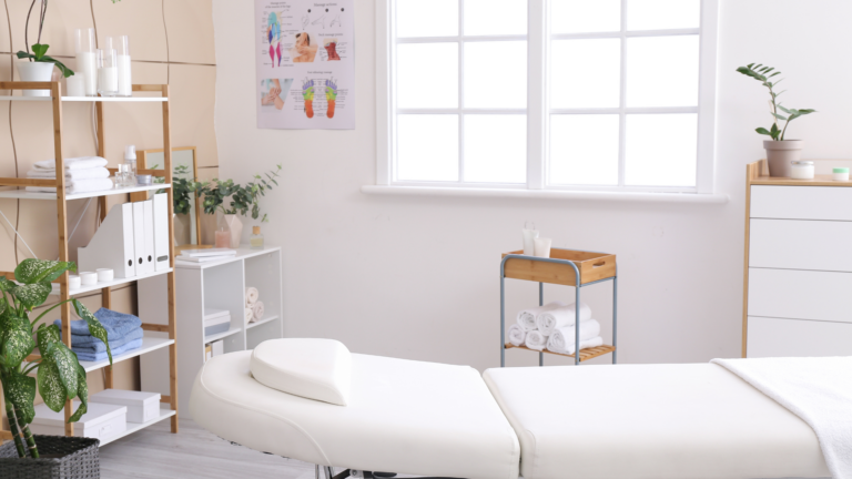 a massage room with white walls and shelves