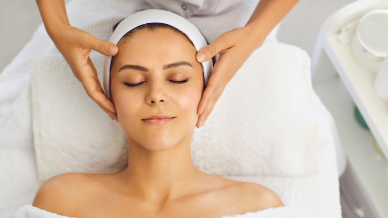 A woman gets a facial massage at a spa