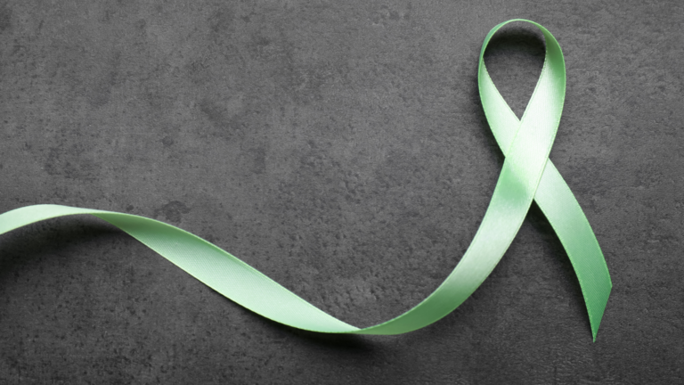 A green ribbon on a black background